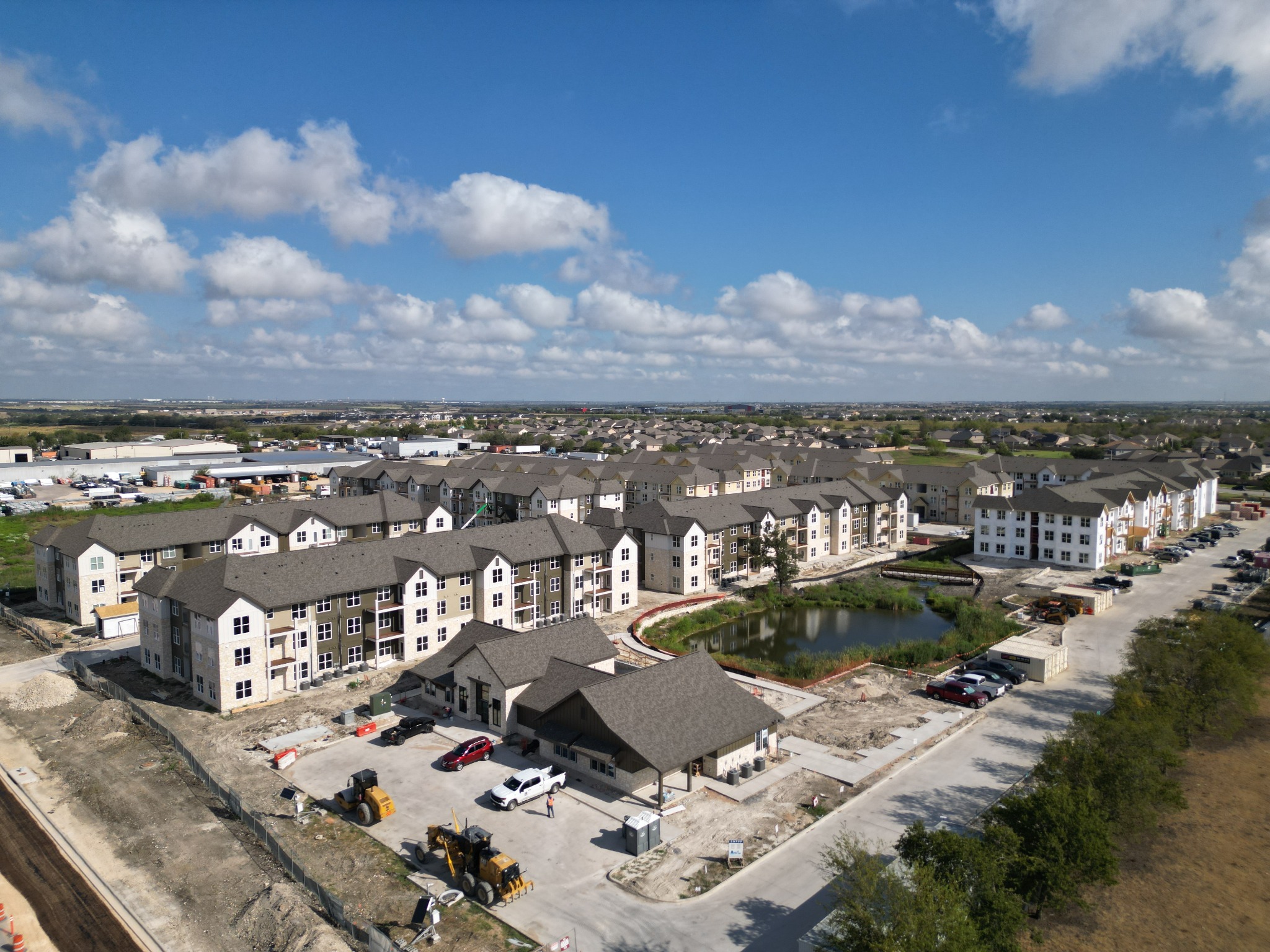 Aerial overview of a multifamily development and active construction site