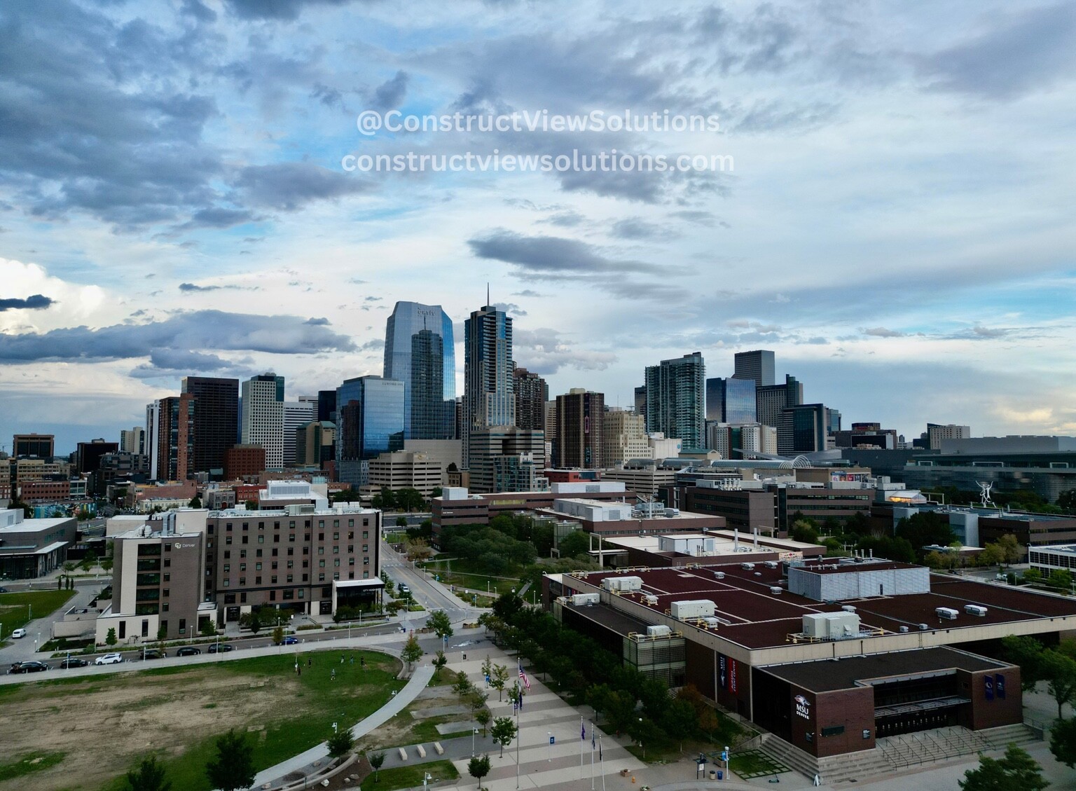 Aerial overview of a downtown skyline, commercial buildings, and surrounding property context